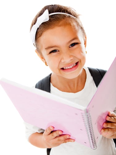 Primary school girl holding a notebook - isolated over a white background